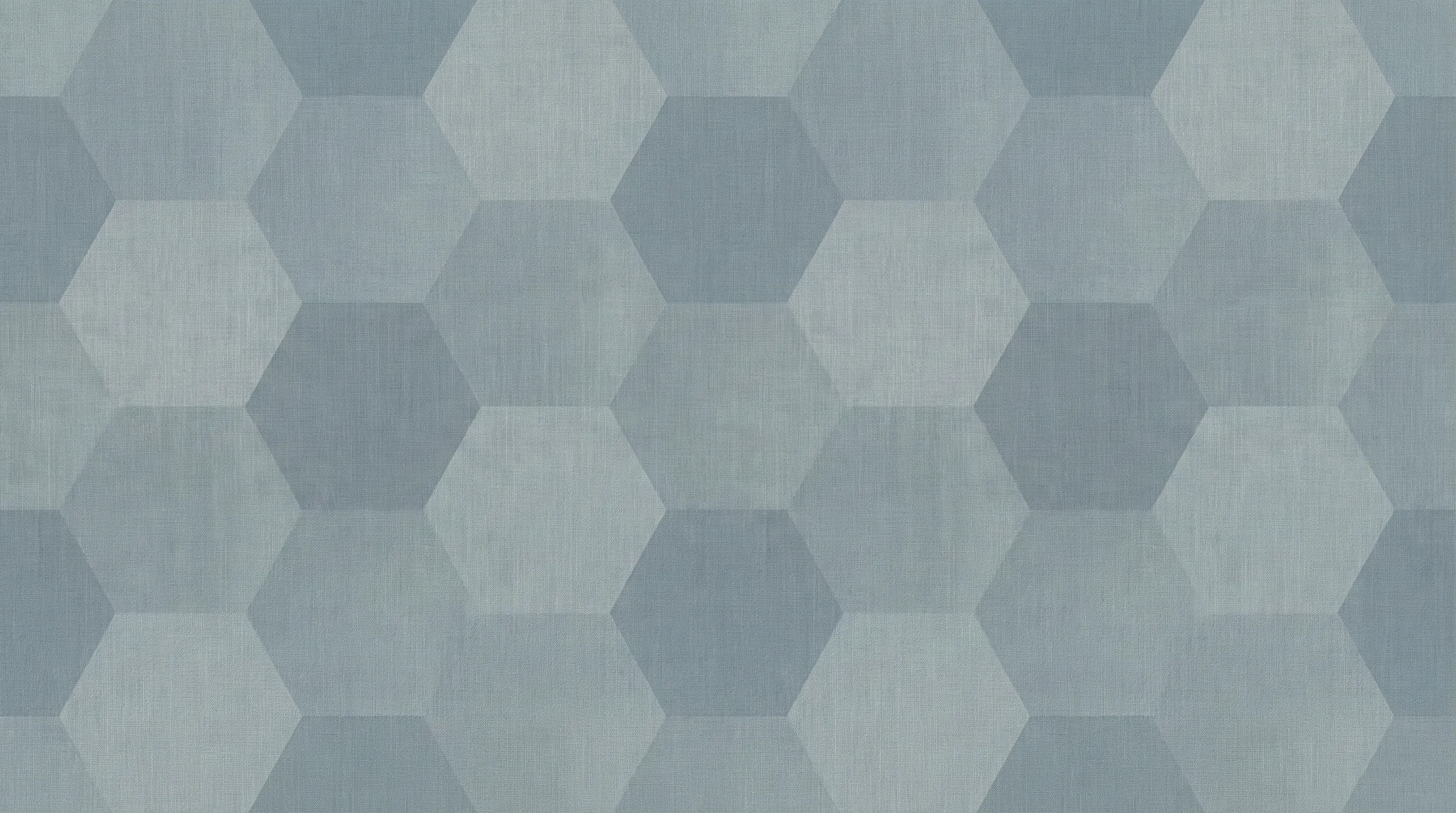 This image presents a seamless geometric pattern composed of interlocking hexagons in various subtle shades of blue and grey. The surface has a textured, faded appearance, resembling woven fabric or distressed linen, which adds depth and a soft, natural feel to the design. It evokes a calm and modern aesthetic, suitable for a background or wallpaper.